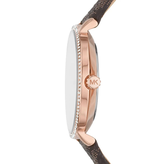 Side profile of Michael Kors Pyper watch showing rose gold case, crystal-set bezel, and brown leather strap