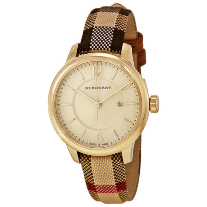 Burberry ladies watch with cream stamped dial, gold case, and honey check fabric strap