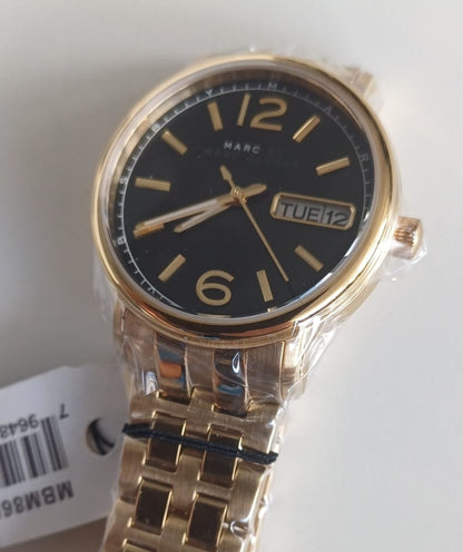 Marc by Marc Jacobs MBM8651 watch worn on wrist with gold-tone stainless steel bracelet