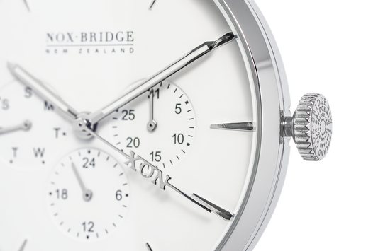 Close-up of Alcyone watch dial showing subdials, applied indices, and textured crown